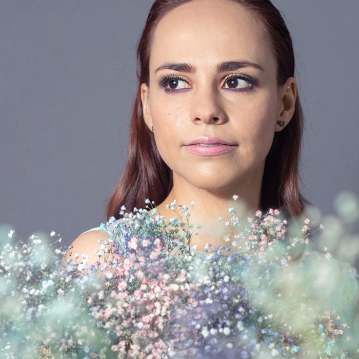 Avery Chen, Lead Design Curator at Dawn Ridge Harbor, reviewing corporate floral arrangements